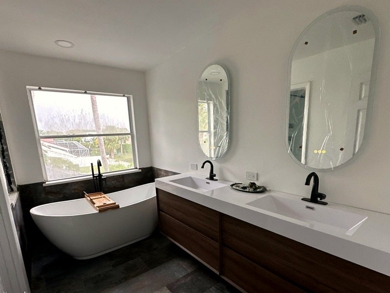 Completed luxury bathroom remodel with freestanding tub and walnut double vanity, Palm Beach County